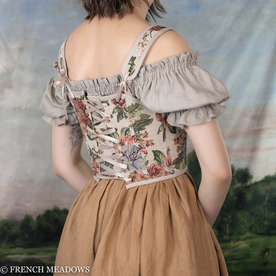 back view of model wearing a floral corset top with adjustable back lacing