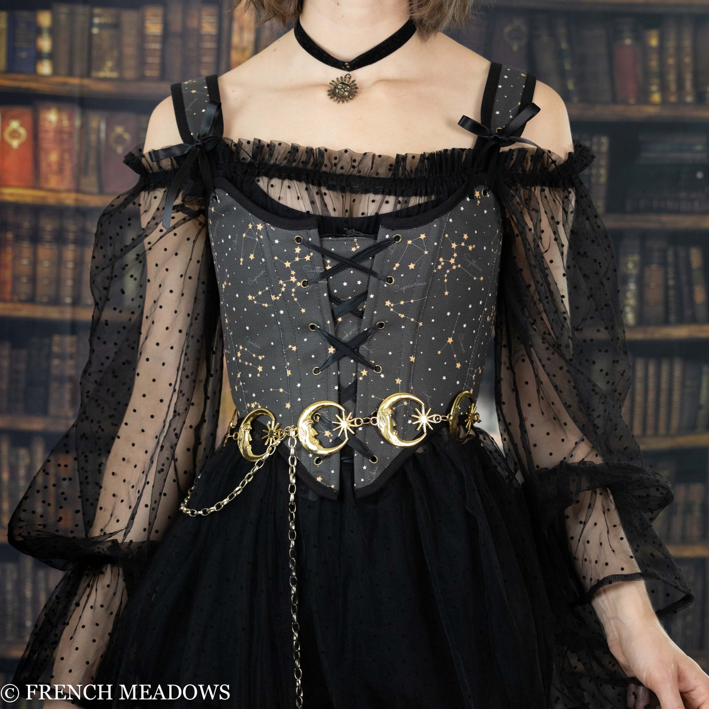 model wearing a black corset top with astrology fabric