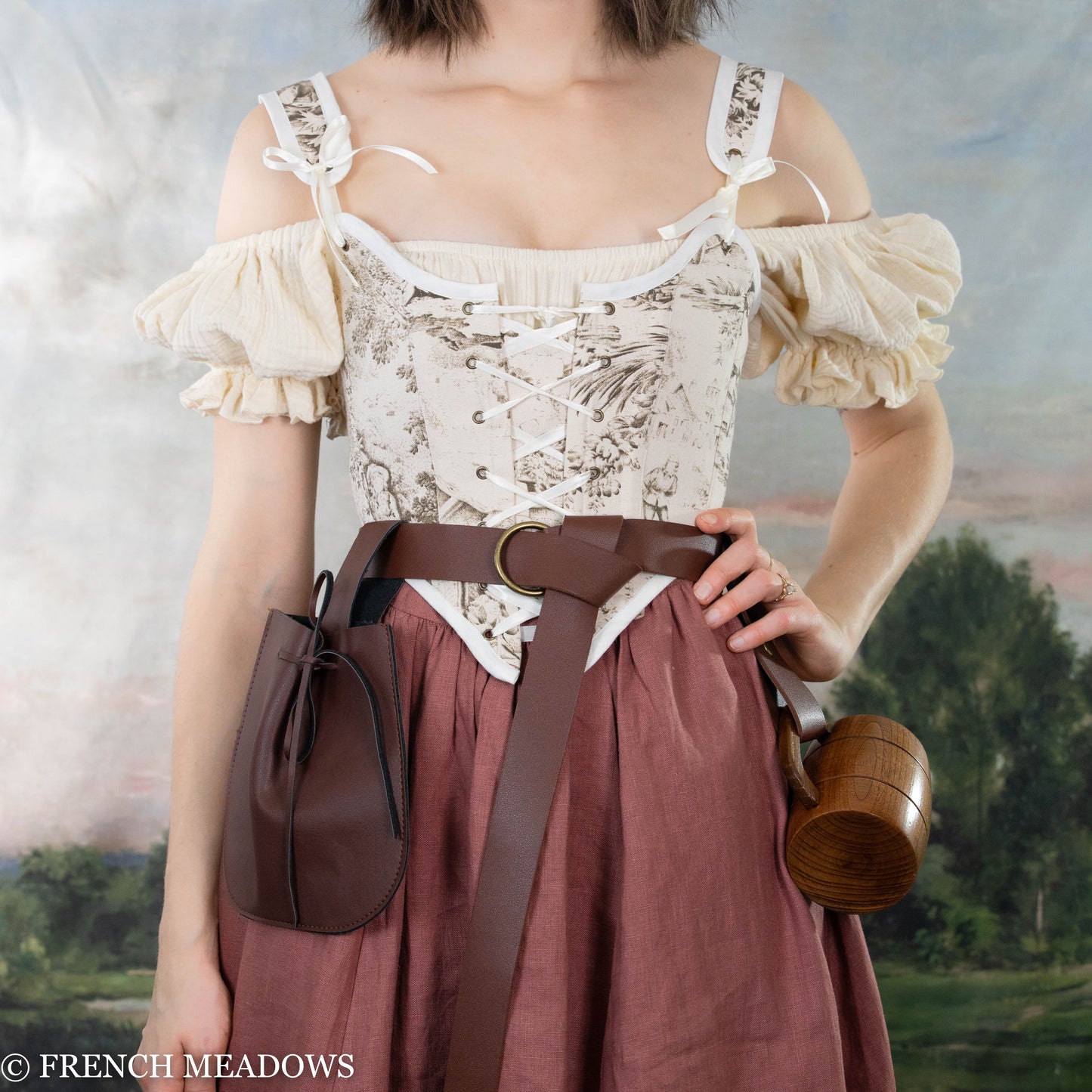 women's renaissance faire costume with light brown corset, rose colored linen skirt and renaissance belt accessories
