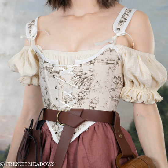 close up view of model wearing a front lacing brown toile corset top