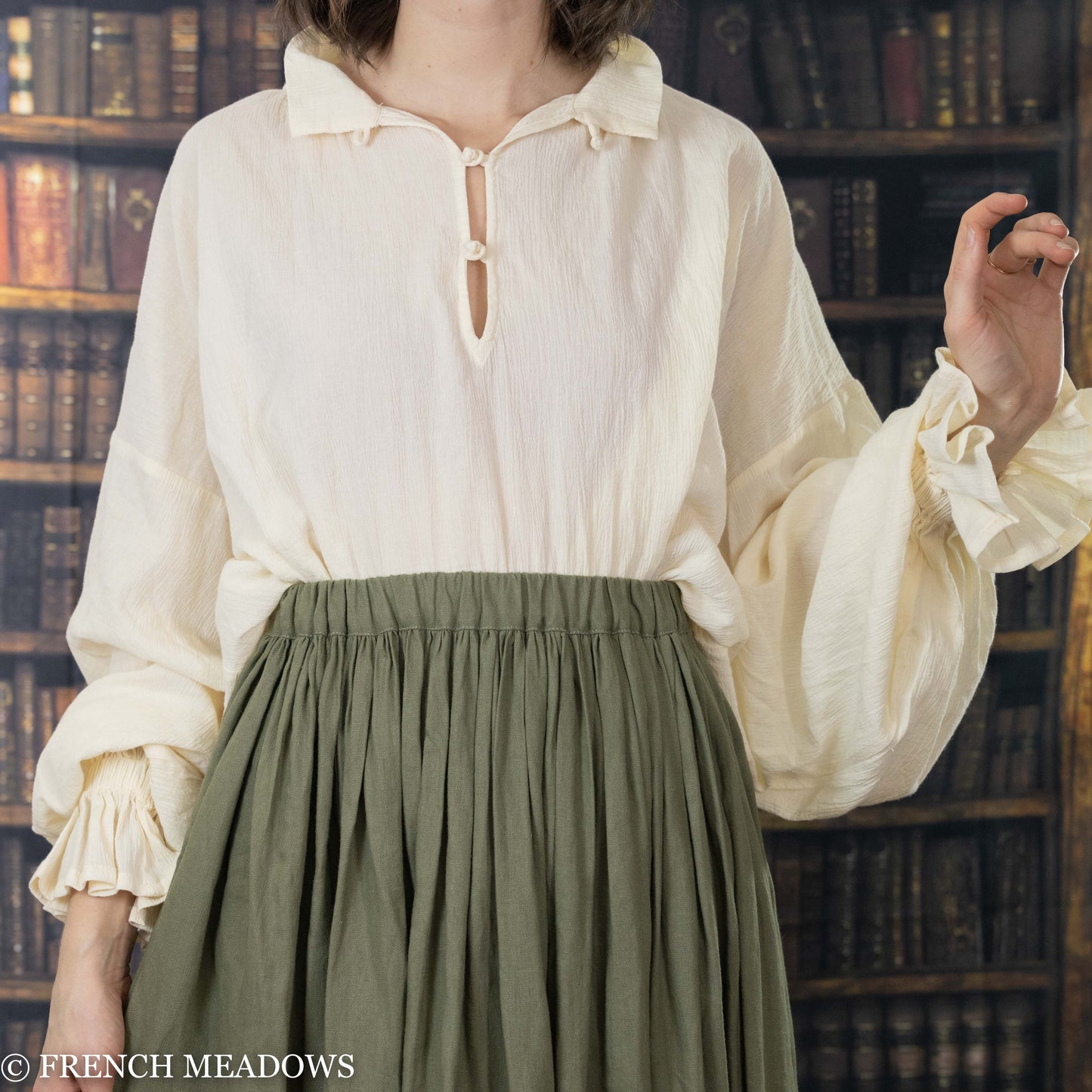 Load image into Gallery viewer, model wearing renaissance tunic tucked in to green linen skirt

