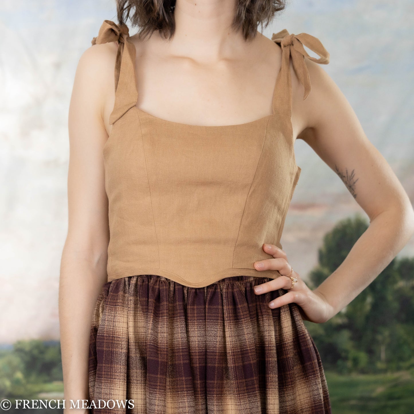 Load image into Gallery viewer, female model wearing a brown corset top with a brown plaid skirt
