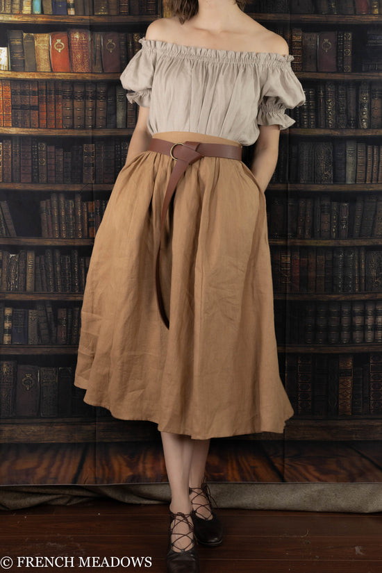 model wearing a midi length linen skirt which ends at around mid calf length on her legs