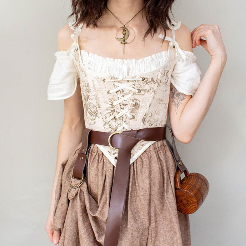 model wearing a brown linen corset with a matching brown linen skirt