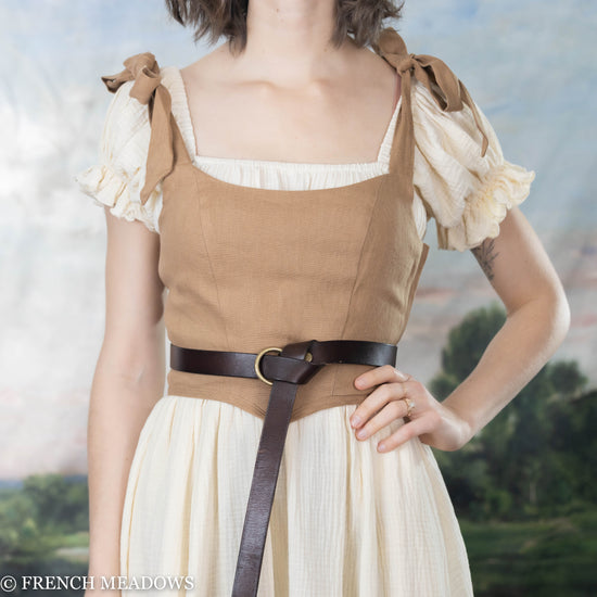 model wearing a brown corset top layered over the white cotton chemise dress