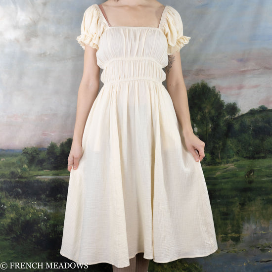 model wearing a romantic ivory cotton dress inspired by cottagecore style