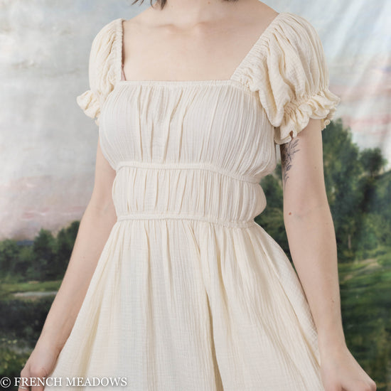 model wearing a soft white cotton milkmaid dress