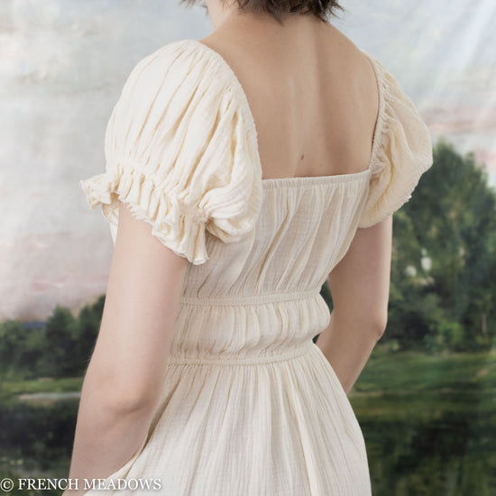 Load image into Gallery viewer, back view of model wearing an ivory cotton milkmaid dress
