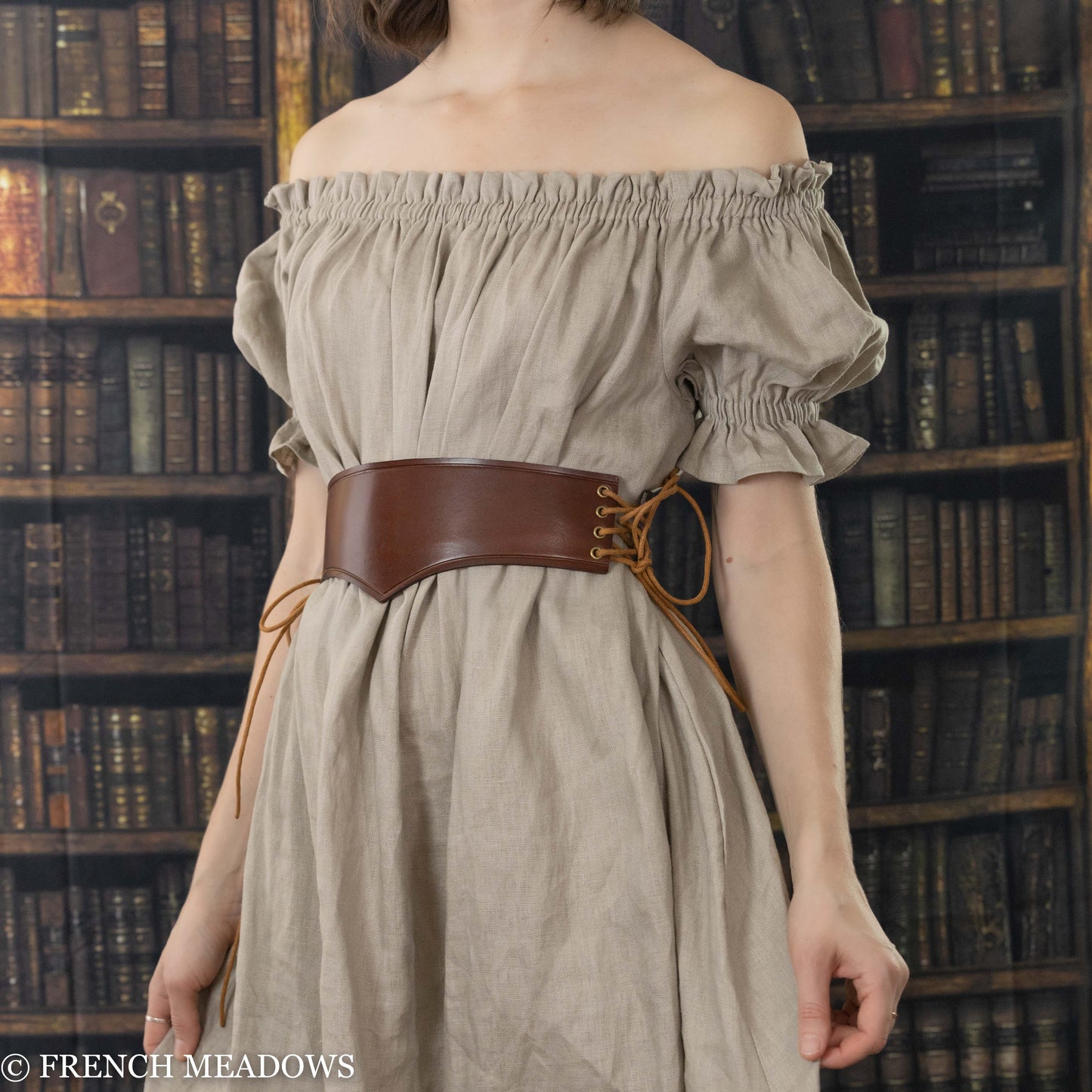 model wearing brown leather waist belt over natural linen renaissance dress