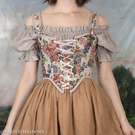 model wearing a floral corset top made of a vintage inspired tapestry fabric