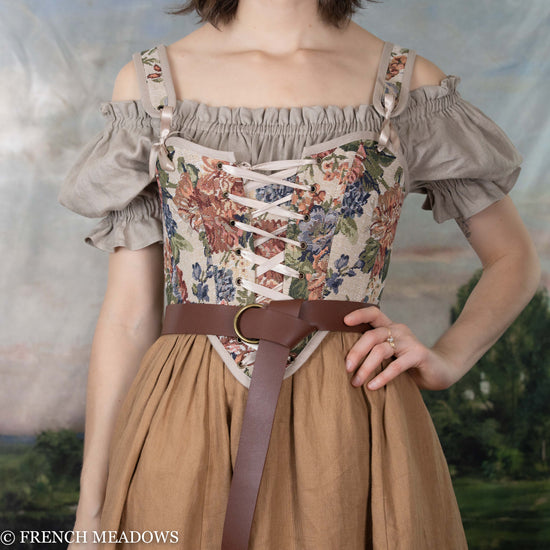 Load image into Gallery viewer, a renaissance faire corset that has removeable straps and a floral corset fabric
