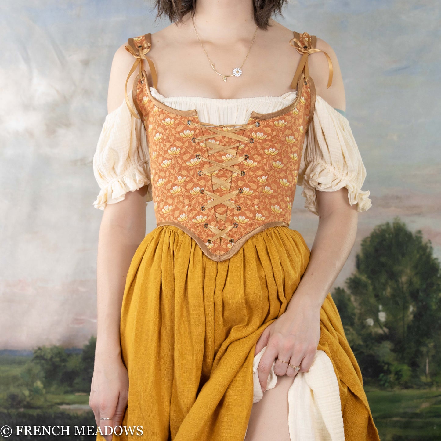 orange floral renaissance costume featuring an orange corset and yellow linen skirt