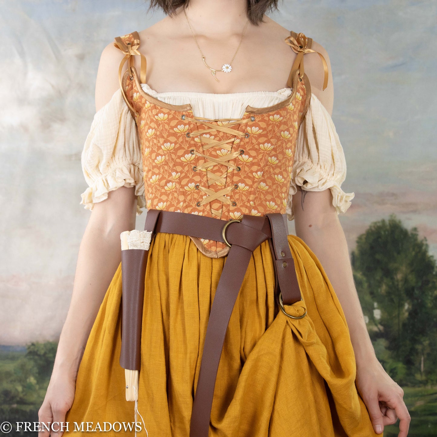 Load image into Gallery viewer, a renaissance faire costume including an orange corset, yellow linen skirt, and leather belt accessories

