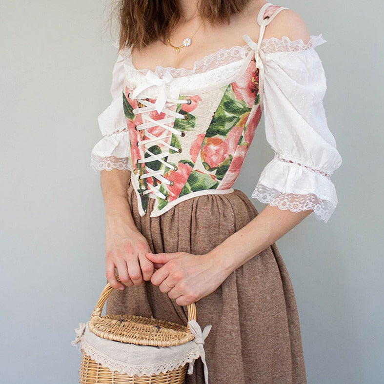 Load image into Gallery viewer, model wearing a renaissance faire costume with a pink floral corset and brown skirt in cottagecore style
