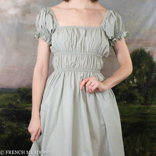 close up view of the milkmaid silhouette of the green cotton milkmaid dress from french meadows