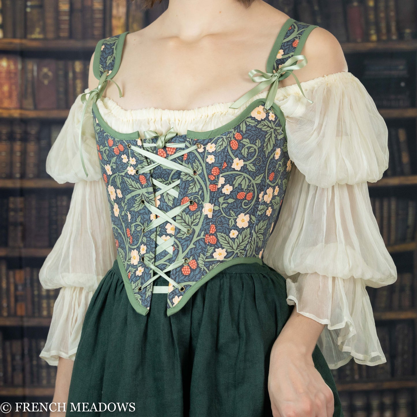 model wearing a green floral corset over a silk chiffon chemise