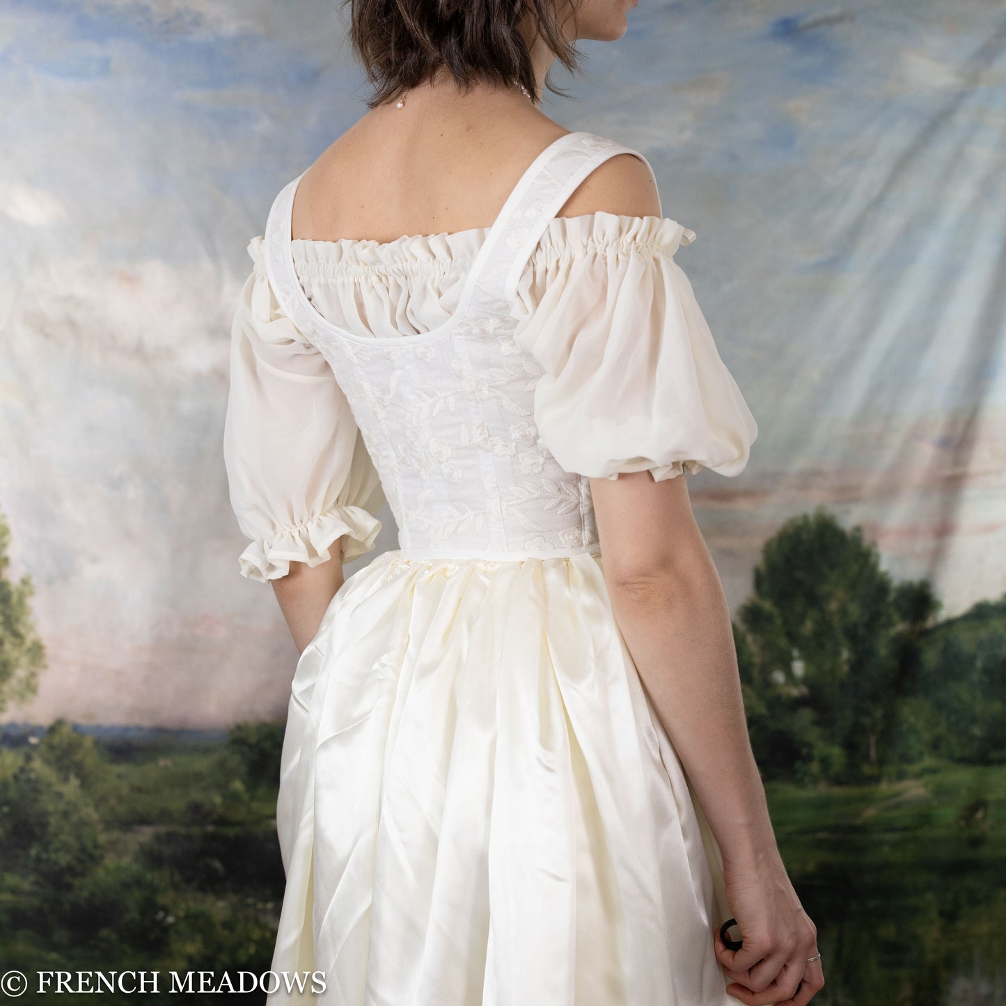 back view of model wearing a white corset wedding dress