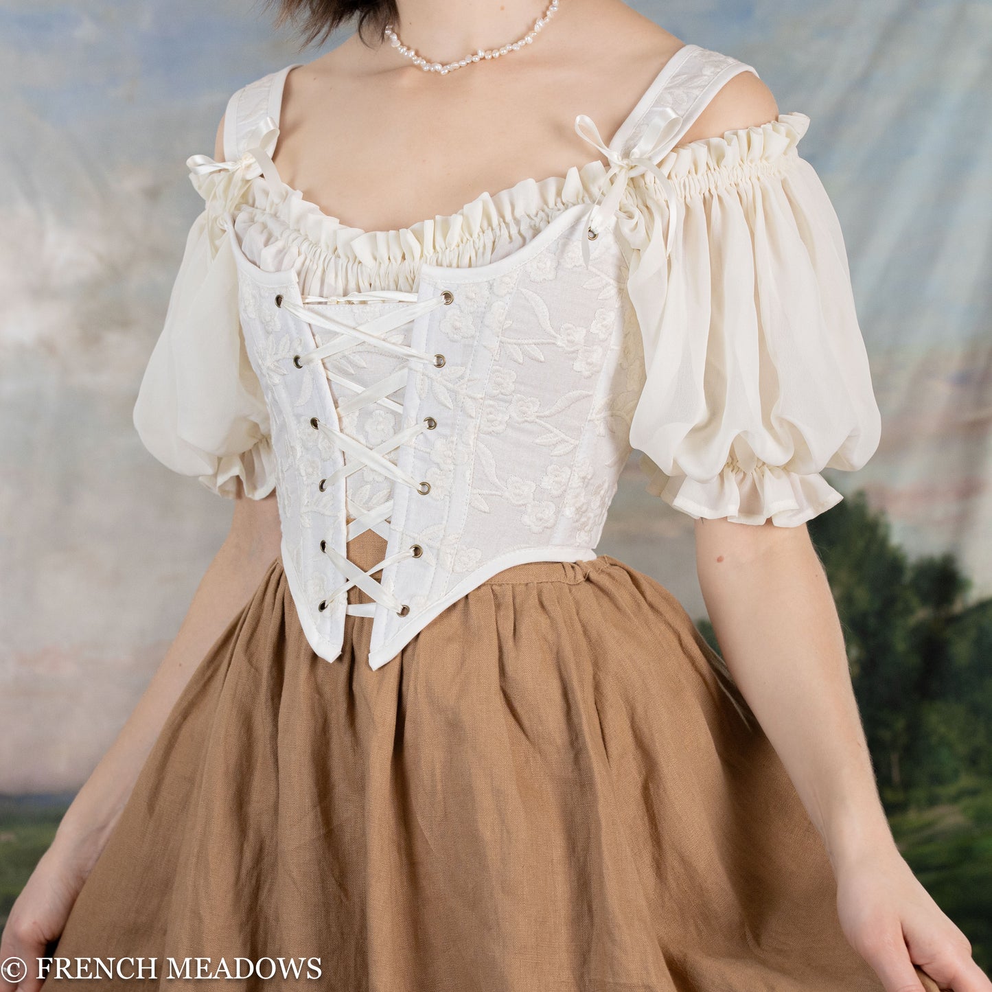 side view of model wearing a white floral renaissance bodice