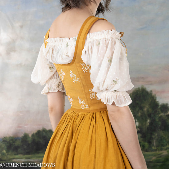 back view of model wearing a yellow floral renaissance corset