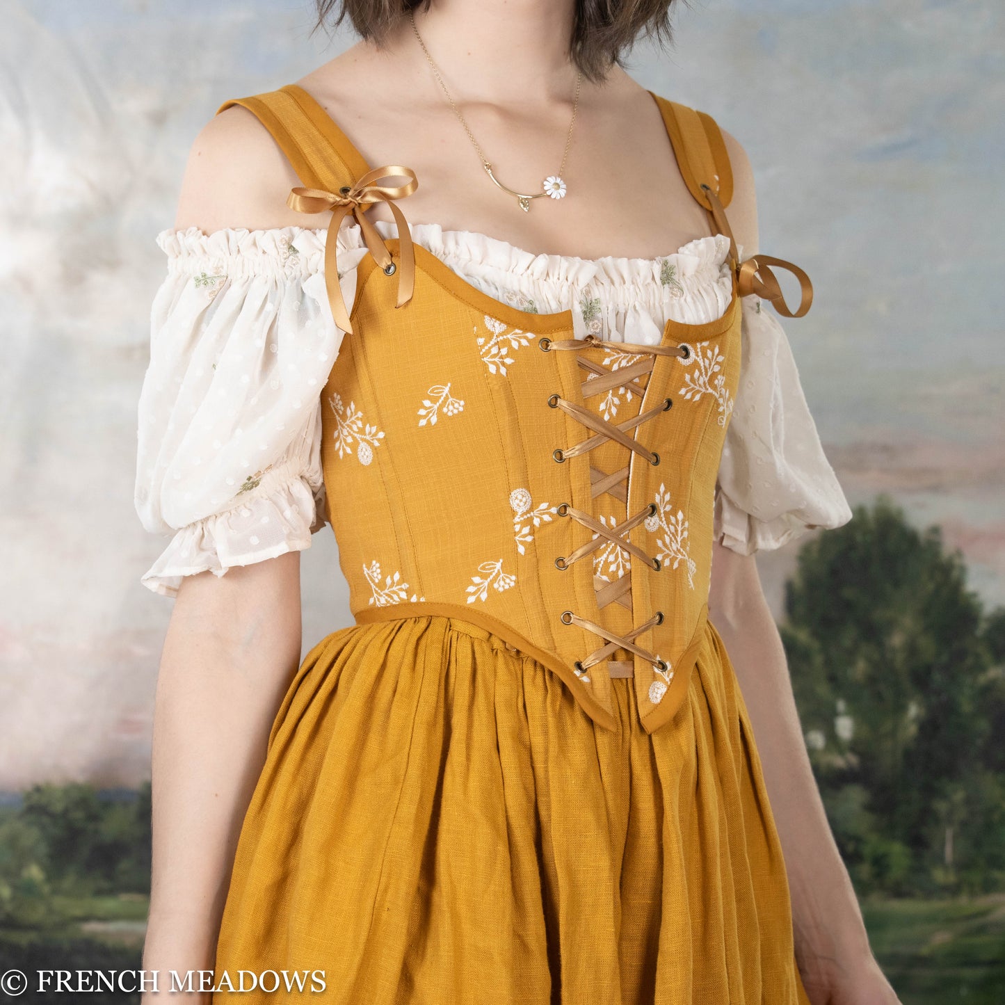 side view of model wearing a yellow floral corset top