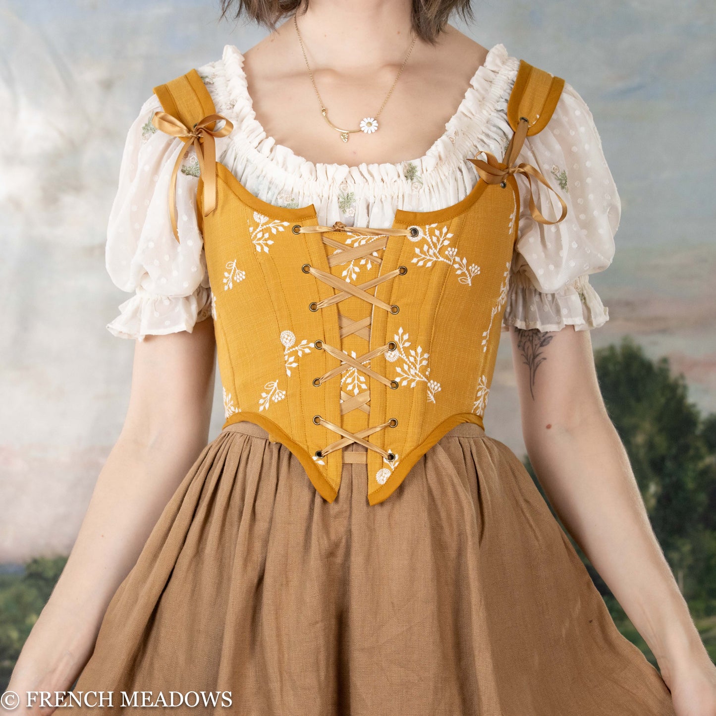 model wearing the yellow corset top paired with a light brown ginger linen skirt